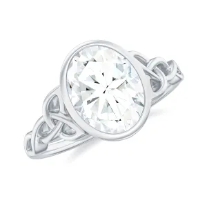 Oval Cut Moissanite Solitaire Celtic Knot Ring in Bezel Setting